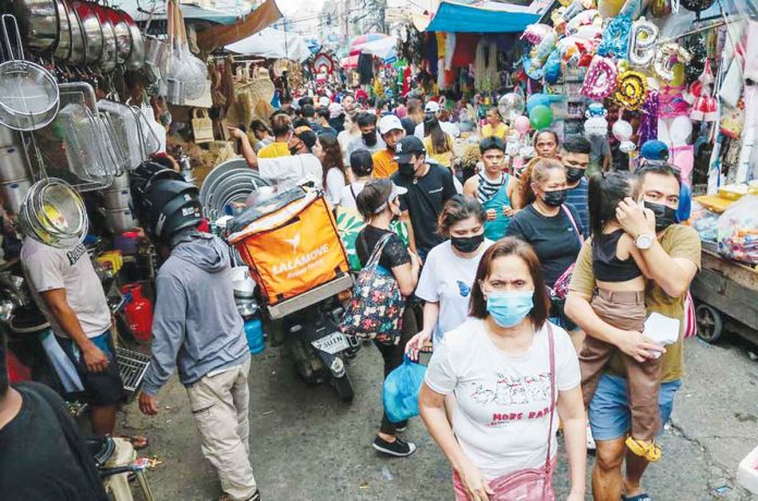 People flock to the Divisoria market to shop for various Christmas decorations and party needs on Nov. 22, 2022. After two years of COVID-19 quarantine measures, people are anticipating a livelier holiday season this year after restrictions and the mask mandate have been lifted. GEORGE CALVELO/ABS-CBN NEWS PHOTO