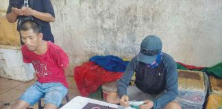 Silay City police arrested fish vendor Renato Espinosa (left) in a drug-buy-bust operation at the Silay public market on Dec. 6. RADYO BANDERA SWEET FM VICTORIAS CITY PHOTO