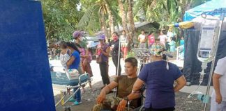 Police Regional Office 6 director, Police Brigadier General Leo Francisco, assures the two wounded personnel of the 1st Antique Provincial Mobile Force Company (1st APMFC) that proper medical attention will be given to them. Photo shows one of the wounded cops receiving treatment. PRO-6 PHOTO