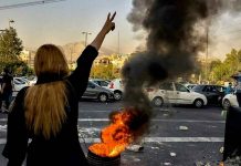 Iranians protest the death of 22-year-old Mahsa Amini after she was detained by the morality police, in Tehran, October 1, 2022. AP Photo