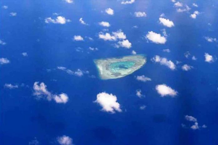 nation-DFA This picture taken on April 21, 2017, shows an aerial view of a reef in the disputed Spratly islands. PHOTO BY TED ALJIBE / AFP