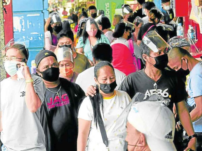MORE PROTECTED. People used to wear face shields on top of masks at the onset of the pandemic. With many already vaccinated, people are now more protected. INQUIRER PHOTO