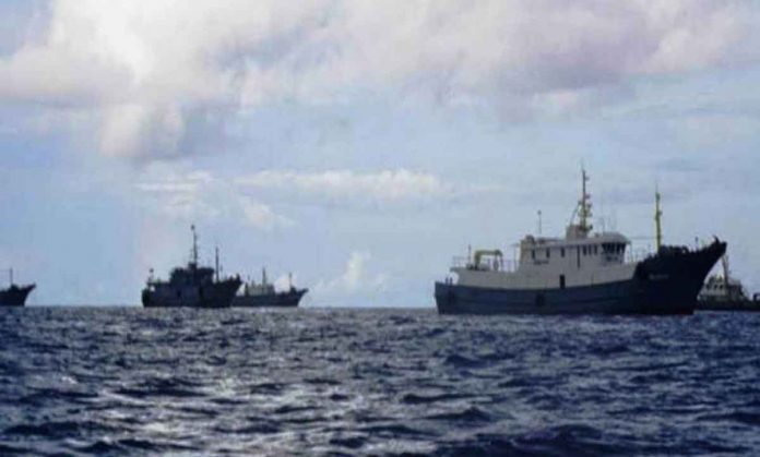 nation-US Several ships believed to be Chinese maritime militia were spotted by fishermen in Iroquois Reef in the West Philippine Sea in this photo taken in September. The military said an average of 25 vessels have been monitored there from September to December based on their patrols. CONTRIBUTED PHOTO