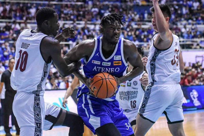 Ateneo de Manila University Blue Eagles’ Angelo Kouame protects the ball from University of the Philippines Fighting Maroons’ Maodo Malick Diouf and Carl Tamayo. UAAP PHOTO