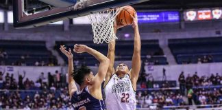 University of the Philippines Fighting Maroons’ Zavier Lucero goes for a two-handed dunk against the defense of National University Bulldogs’ Jolo Manansala. UAAP PHOTO