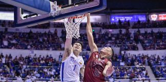 Ateneo de Manila University Blue Eagles’ Bryson Ballungay scores on a dunk against the defense of the University of the Philippines Fighting Maroons’ Zavier Lucero. UAAP PHOTO