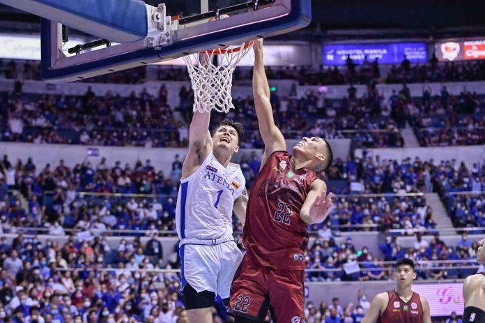 sports-ateneo-pic-and-caption Ateneo de Manila University Blue Eagles’ Bryson Ballungay scores on a dunk against the defense of the University of the Philippines Fighting Maroons’ Zavier Lucero. UAAP PHOTO