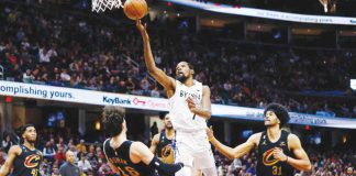 Brooklyn Nets forward Kevin Durant (7) shoots against Cleveland Cavaliers forward Cedi Osman (16) and center Jarrett Allen (31) during the second half of their NBA basketball game, Monday, Dec. 26, 2022, in Cleveland. AP