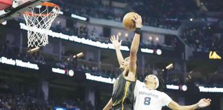 Golden State Warriors Jordan Poole (No. 3) shoots while being defended by Memphis Grizzlies forward Ziaire Williams (No. 8) during the first half of an NBA basketball game in San Francisco, Sunday, Dec. 25, 2022. AP