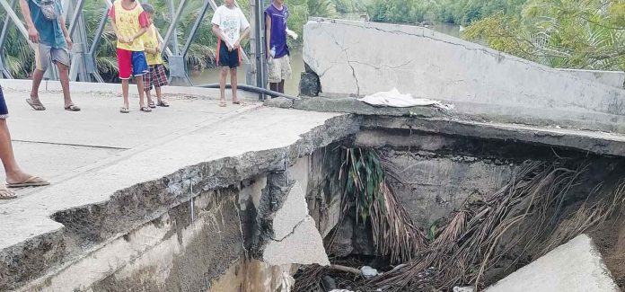 Hamtic-bridge A bridge approach collapsed in Hamtic, Antique, on Tuesday, Jan. 17. The Municipal Disaster Risk Reduction and Management Office said the heavy rains may have eroded the soil under the structure, causing it to collapse. LEO PATRICK RIZARDO FACEBOOK PHOTO
