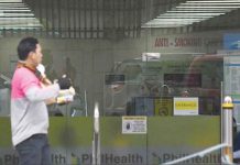 Marcos suspends PhilHealth contribution hike A delivery rider walks in front of the Philippine Health Insurance Corp. (PhilHealth) office. President Ferdinand Marcos Jr. instructs PhilHealth to defer the contribution hike this year based on the current economic conditions. ABS-CBN NEWS PHOTO