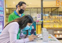 Sales representatives of a telecommunications company assist clients in registering their prepaid subscriber identity module (SIM) at the gadgets section of the Greenhills Shopping Center in San Juan City. JONATHAN CELLONA, ABS-CBN NEWS PHOTO