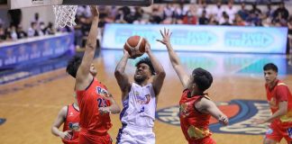 TNT Tropang Giga’s Mikey Williams is forced to a tough basket by the defense of Rain or Shine Elasto Painters’ Norbert Torres and Anton Asistio. PBA PHOTO
