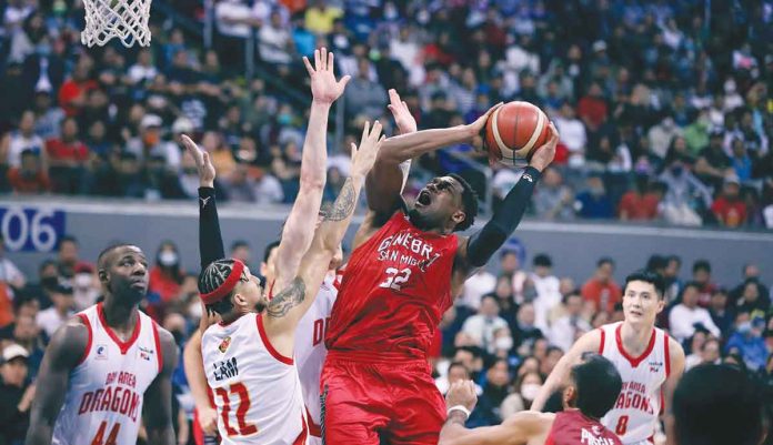 sports-ginebra Barangay Ginebra San Miguel Kings’ Justin Brownlee is forced to a tough basket by Bay Area Dragons’ Kobey Lam. PBA PHOTO