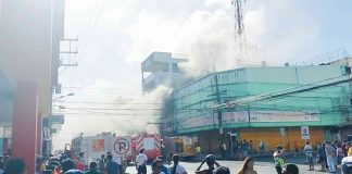 BUILDING ON FIRE. Thick smoke billows from this fire-hit three-storey commercial building in Barangay 37, Bacolod City on Sunday. Property damaged is pegged at over P20 million, according to the Bureau of Fire Protection. As of press time, the cause of the blaze remains unknown. MAE SINGUAY/PN