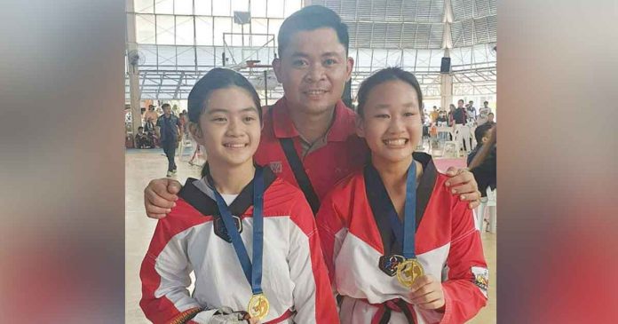 iloilo-taekwondo Iloilo MVP Taekwondo Gym head coach Denmark Pinggol with two of his taekwondo jins. PHOTO COURTESY OF DENMARK PINGGOL