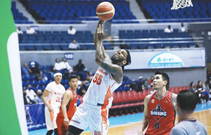 NorthPort Batang Pier’s Kevin Murphy goes for a tough basket as Blackwater Bossing’s Jeth Troy Rosario looks on. PBA PHOTO
