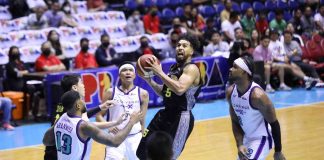TNT Tropang Giga’s Mikey Williams splits on three Converge FiberXers defenders for a layup. PBA PHOTO