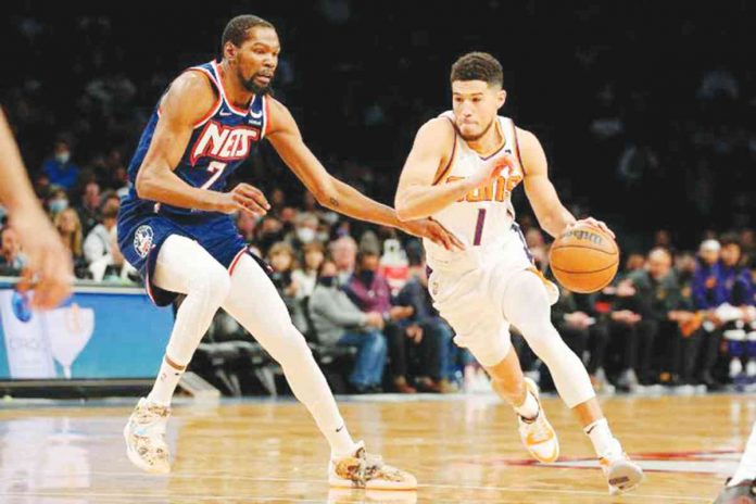sports kevin Kevin Durant (left) will now team up with Devin Booker (right) at Phoenix Suns. GETTY IMAGES