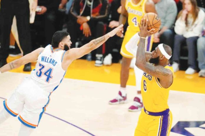 sports lebron SHOT AT HISTORY. Los Angeles Lakers' LeBron James with a fadeaway shot over Oklahoma City Thunder's Kenrich Williams to clinch the no.1 spot in NBA's career scoring leader in the regular season. GETTY IMAGES