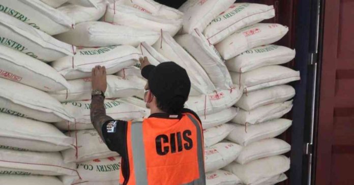 smuggled onions, sugar A personnel of the Customs Intelligence and Investigation Service examines sacks of smuggled sugar and onions in this undated photo. The Bureau of Customs on Sunday, March 5, said it found smuggled agricultural products worth P101.6 million in 17 shipments at the Manila International Container Port during inspections on Feb. 27 and 28. BOC PHOTO