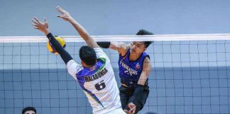 SPIKERS’ TURF PHOTO. D’Navigators-Iloilo’s Jade Disquitado scores against the defense of Imus AJAA Spikers’ Kim Malabunga.
