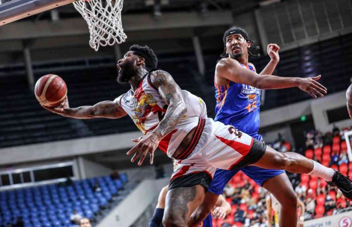 sports san pic and caption San Miguel Beermen’s Cameron Clark goes for a tough reverse basket as he evades the defense of NLEX Road Warriors’ Brandon Ganuelas-Rosser. PBA PHOTO