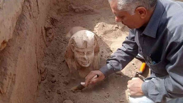 An archaeological worker unearths a Sphynx statue in Egypt. EPA