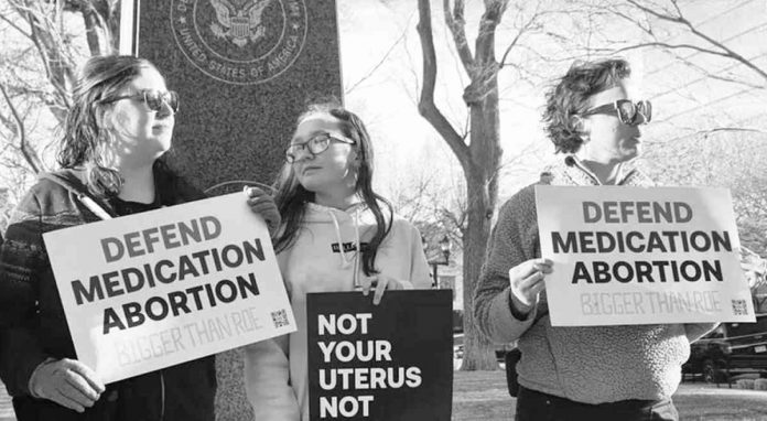 world-us Protesters in Texas hold signs reading “defend medical abortion”. GETTY IMAGES