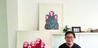 Painter Julius Redillas, first artist-in-residence of Istaran, with two of his watercolors (now in private collections) produced during his two-month residency in KANTINA, Roxas City.