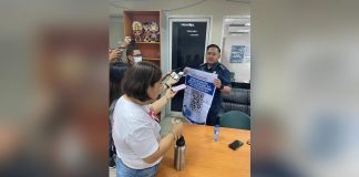 Police Colonel Noel Aliño, acting director of Bacolod City Police Office, shows the QR (quick response) code for the “Isugid kay Mayor” online complaints desk to reporters during his visit to the Government Center on Wednesday, April 19. BACOLOD CITY PIO PHOTO
