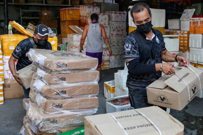 Customs_digitalization_resized Operatives of the National Bureau of Investigation, Bureau of Customs, Bureau of Permits, and the Veterinary Inspection Board conduct a raid inside a compound in Juan Luna Street, Tondo Manila containing banned meat products and medical supplies in this file photo. ABS-CBN NEWS PHOTO