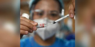 A health worker prepares a dose of Gamaleya National Center of Epidemiology and Microbiology’s Sputnik V Covid-19 vaccine during a vaccination for residents in Mandaluyong City, suburban Manila on July 15, 2021. AFP