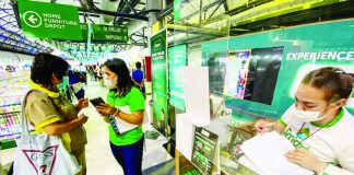 A sales representative of a telecommunications company assists clients register their prepaid subscriber identity module (SIM) cards. The registration has been extended for another 90 days or until July 25, 2023. ABS-CBN NEWS PHOTO