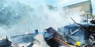 Smoke billows from a pile of corrugated galvanized iron sheets – ruins of a house and fruit stand that fire struck in Numancia, Aklan on April 1.