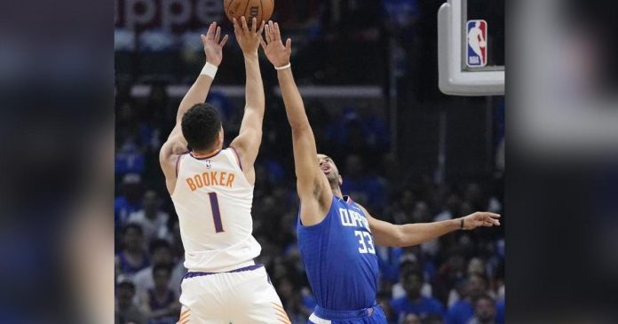 sports NBA_superimposed Phoenix Suns’ Devin Booker goes for the basket as LA Clippers’ Nicolas Batum tries to block the shot. AP