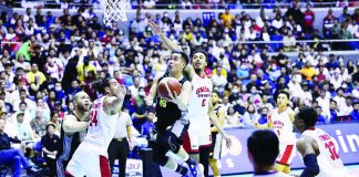 Bacolodnon Kib Montalbo of TNT Tropang Giga evades the defense of Barangay Ginebra San Miguel Kings’ Christian Standhardinger and Jeremiah Gray for a tough basket. PBA PHOTO
