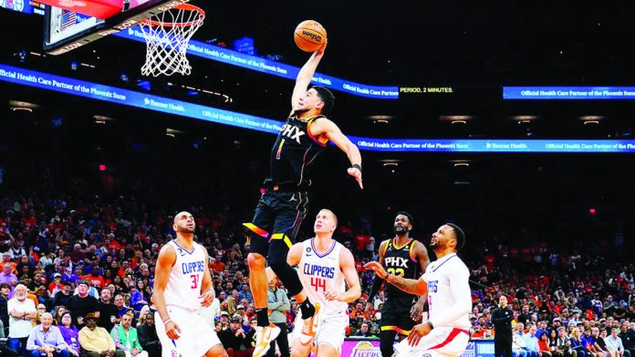 sports_NBA_resized DEVIN Booker of the Phoenix Suns becomes just the third player in the past 25 seasons to score at least 25 points in a quarter during a playoff game. AP