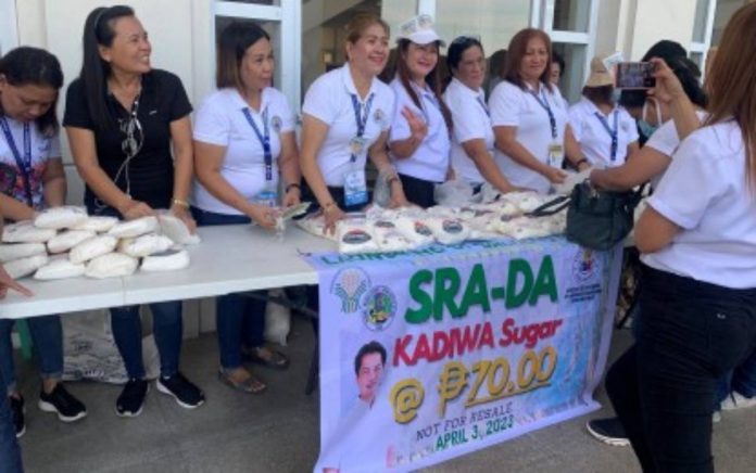 sugar Personnel of the Bacolod City Cooperative and Livelihood Development Office sell Kadiwa sugar supplied by Victorias Milling Company at P70 per kilo during the launching of the program at the Government Center on Monday, April 3. BACOLOD CITY PIO PHOTO VIA PNA