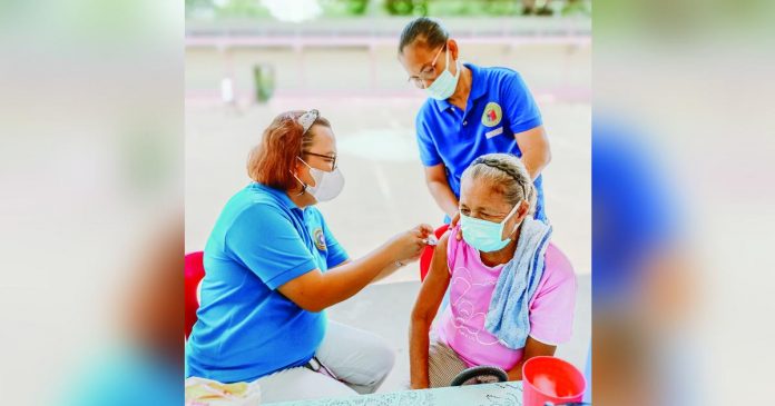 vax pic_superimposed A senior citizen gets her dose of anti-COVID-19 vaccine at the municipal health center of Dueñas, Iloilo. DUEÑAS MUNICIPAL HEALTH OFFICE FB PHOTO