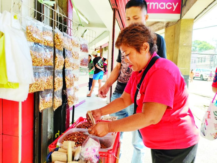 vendor_2_resized Several street food vendors in Iloilo City expressed frustration over the proposed ordinance that seeks to restrict street food vending. They said it will worsen their situation. AJ PALCULLO/PN