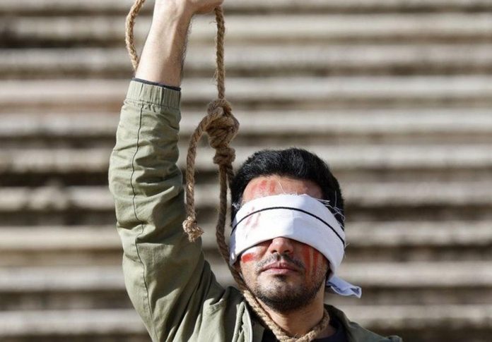 world_iran_resized A man protests in Lisbon, Portugal against Iran’s execution in December 2022 of two men over the anti-government protests. EPA