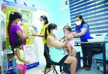 Community members enjoy free medical check-ups inside the child-friendly local health center refurbished by SM Foundation Inc.