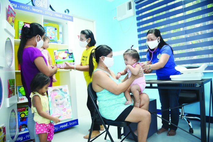 1_resized Community members enjoy free medical check-ups inside the child-friendly local health center refurbished by SM Foundation Inc.