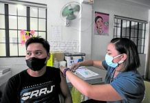 JAB FOR WORK. A resident of Pasig City receives his first dose of COVID-19 vaccine at Rosario Super Health Center on Monday. He says he finally decided to get vaccinated due to work requirements. LYN RILLON, PHILIPPINE DAILY INQUIRER