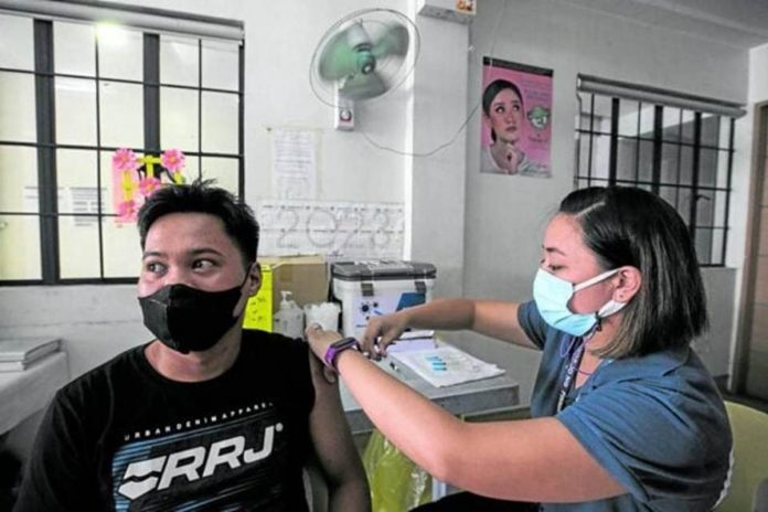 DOH_resized JAB FOR WORK. A resident of Pasig City receives his first dose of COVID-19 vaccine at Rosario Super Health Center on Monday. He says he finally decided to get vaccinated due to work requirements. LYN RILLON, PHILIPPINE DAILY INQUIRER