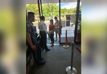 Facemask use in city gov’t offices mandatory anew Security personnel make sure that all individuals entering the Iloilo City Hall premises are wearing facemasks. GLENDA TAYONA/PN