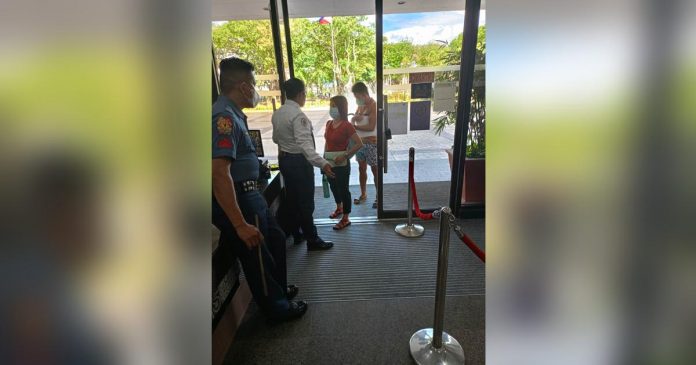 Facemask use_superimposed Security personnel make sure that all individuals entering the Iloilo City Hall premises are wearing facemasks. GLENDA TAYONA/PN