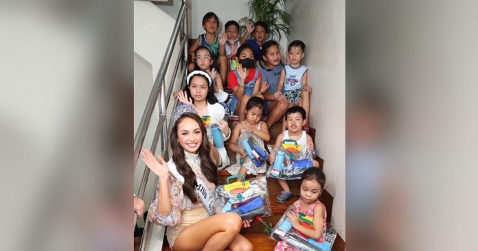 Miss Universe_superimposed Miss Universe R'Bonney Gabriel visited the street where her father grew up in Manila. She handed out school supplies to the children in the community.