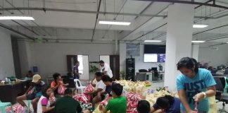 Personnel of the Passi City Disaster Risk Reduction and Management Council, members of the Kabataan Kontra Droga at Terorismo-Passi City Chapter and volunteers prepare for the distribution of relief goods to flood-hit families. PASSI CDRRMO PHOTO